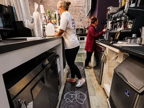 Custom anti-fatigue logo mat behind a service counter