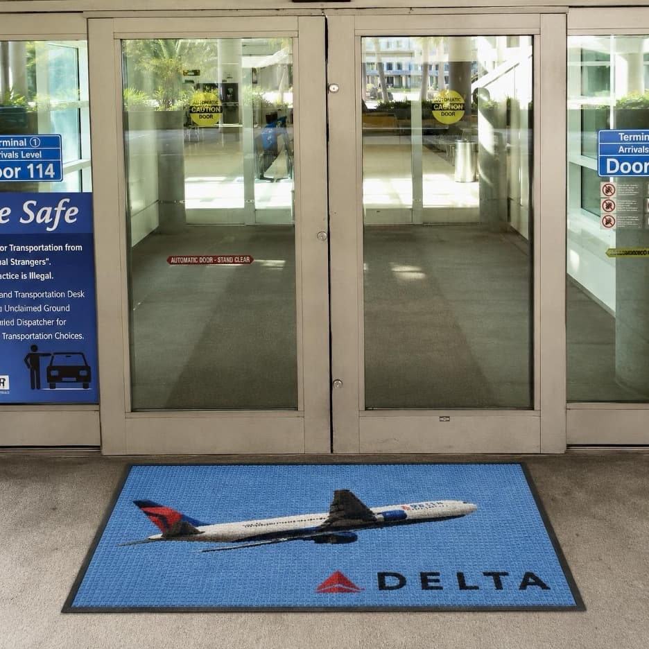 WaterHog HD Logo Mat installed at an airport entrance