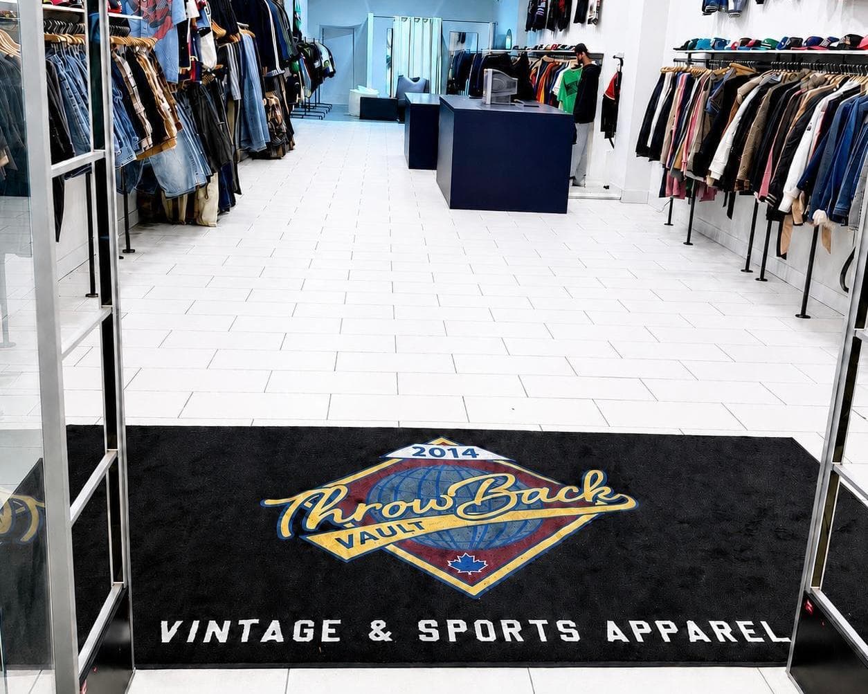 ThrowBack Vault custom logo mat at a clothing store entrance