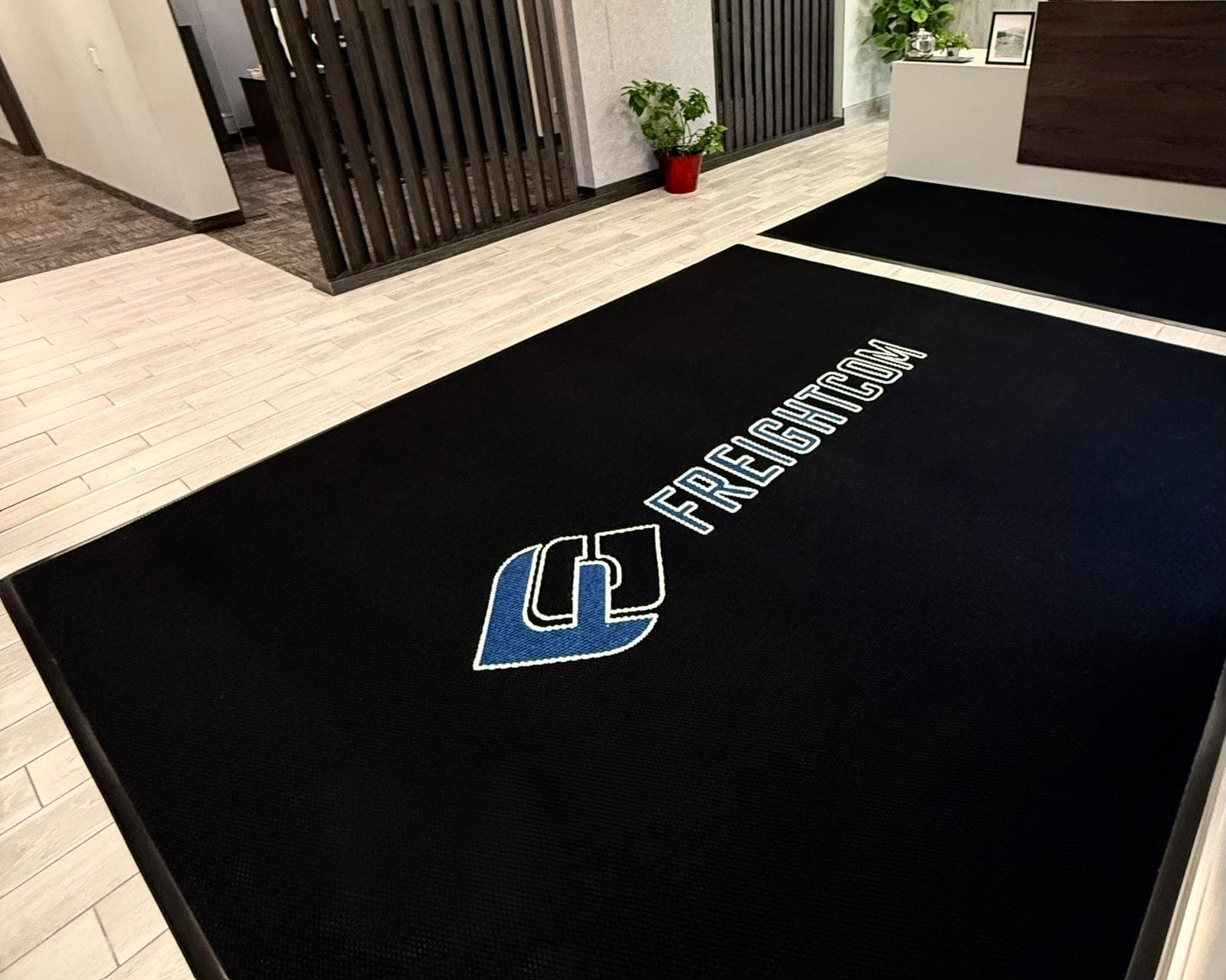 Frechecon custom logo mats installed in an office lobby